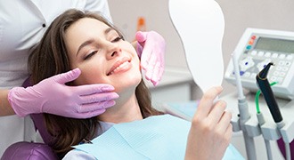 woman smiling while visiting cosmetic dentist 