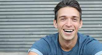 man smiling after getting cosmetic dentistry 