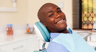 Man smiles with dentures in Tyler