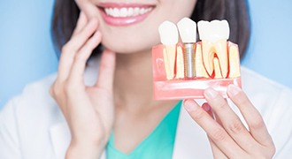 Woman admiring her new dentures in Tyler