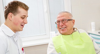 Denture dentist in Tyler speaking with an older patient