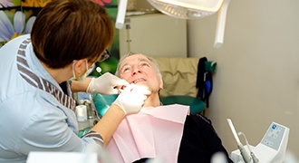 Denture dentist in Tyler performing exam on a patient