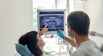 dentist showing a patient their X-rays 