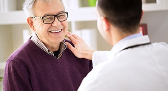 dentist talking to patient about dental implants in Tyler