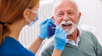 Mature man smiling during dental checkup 