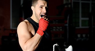 Man placing mouthguard in mouth before working out