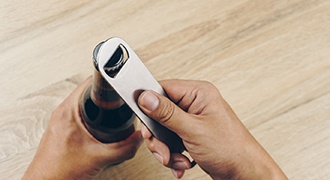 Man using bottle cap opener