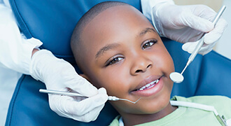 Child getting dental exam with Tyler dentist