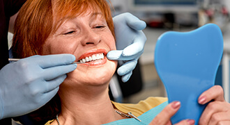 Smiling woman being examined by Dr. Donna Franklin-Pitts