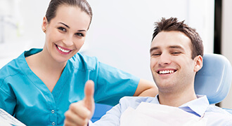 Smiling Tyler dental patient with hygienist