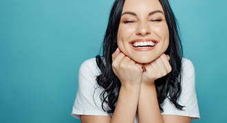 Woman smiling after receiving teeth whitening treatment in Tyler