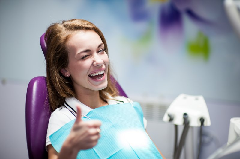 young woman in dentist chair smiling