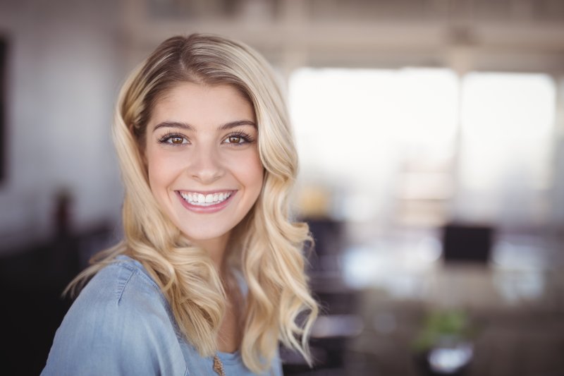 person with porcelain veneers smiling